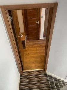 a hallway with a wooden door in a room at Cosy studio flat in Muswell Hill in London