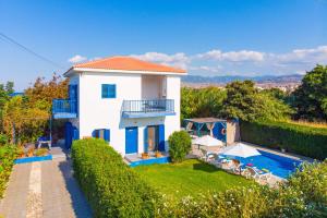 a villa with a swimming pool and a house at Villa Chara in Paphos