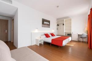 a bedroom with a bed with red pillows on it at Intur Orange in Benicàssim