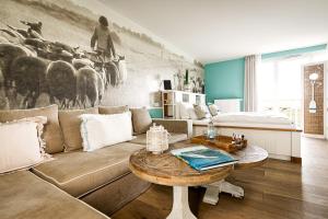 a living room with a couch and a table at Hotel Zweite Heimat in Sankt Peter-Ording