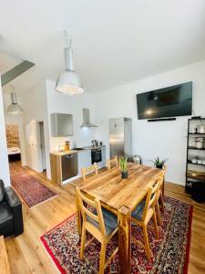 a dining room with a wooden table and chairs at Charmantes Apartment in zentraler Lage in Braunschweig +18 photos