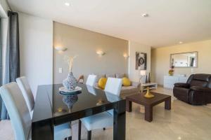 a living room with a dining table and a couch at Marina Vilamoura - Aquamar 401- Modern Apartment in Vilamoura