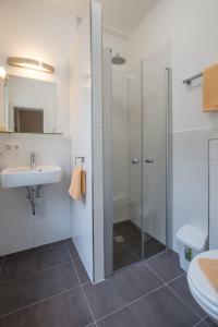 a bathroom with a shower and a sink at Hotel Scheffelhof in Konstanz