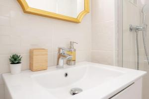 a bathroom with a white sink and a shower at Cabana & Le Mimosa Ensoleillé - Plage, Box, Terrasse in Bormes-les-Mimosas