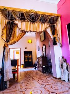 a living room with a curtain and a table at Safari Abu Simbel in Abu Simbel