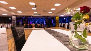 a table with a vase of flowers on it at Newquay Bay Resort 181 in Newquay Bay Resort +39 photos