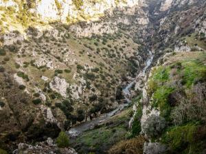 a canyon with a river in the middle at L'Antica Conceria in Matera