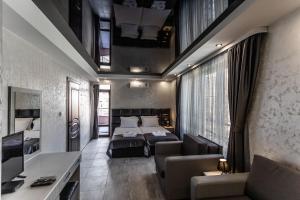 a hotel room with a bed and a living room at Никонел in Oborishte