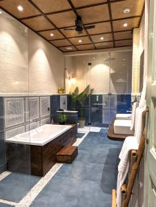 a large bathroom with a tub and a shower at Cape House - Presidential Suite in Amritsar