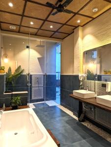 a large bathroom with two sinks and a tub at Cape House - Presidential Suite in Amritsar