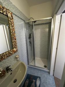 a bathroom with a shower and a sink at Rose in Tirrenia +2 photos