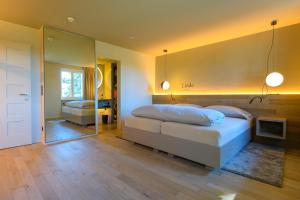 a bedroom with two beds and a mirror at Landhotel Linde Fislisbach in Baden