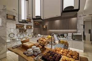 a kitchen with a bunch of different types of bread at Pan Pacific Serviced Suites Kuala Lumpur in Kuala Lumpur