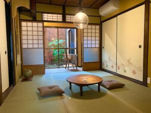 a room with a table in the middle of a room at TSUDOYA 天王寺 in Osaka