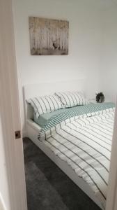 a white bed in a room with a picture on the wall at Immaculate 1-Bed Apartment in Hinckley in Hinckley