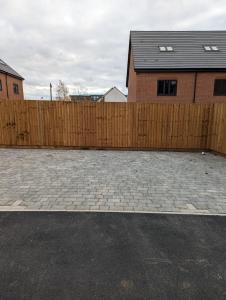 a wooden fence in front of a house at Immaculate 1-Bed Apartment in Hinckley in Hinckley