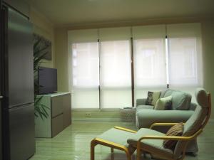 a living room with a couch and a tv at Cal Xambu in Cambrils