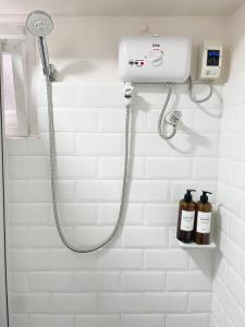 a shower in a bathroom with a shower head at Ba-lai homes in Baguio