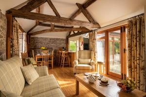 a living room with a couch and a table at Garden Cottage at Eaton Manor in Eaton