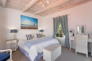 a bedroom with a bed and a desk and a window at Morningside Cottage in Tokai +19 photos