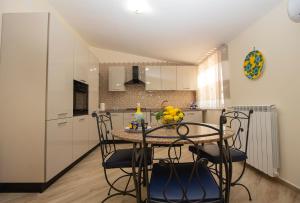 a kitchen with a table and chairs in a room at Casa Landi in Cetara