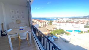 a balcony with a table and a view of a city at Acapulco b5 in Roses