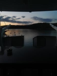 a view of a boat in the water at sunset at Motor Yacht Cadabra in Rab