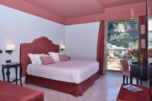 a hotel room with a bed and a balcony at Hotel Royal Positano in Positano