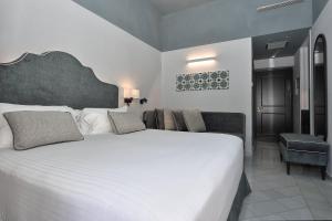 Postel nebo postele na pokoji v ubytování Hotel Royal Positano