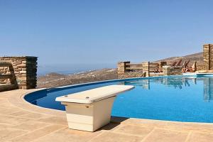a trash can sitting next to a swimming pool at Cycladic house with panoramic view in Ktikádhos