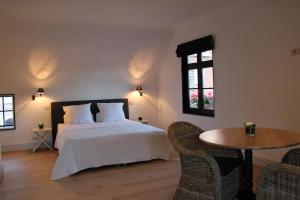 Rúm í herbergi á Guesthouse Villa Vauban