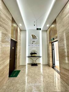 a lobby of a grand tower with a sign on the wall at Homestay Honey Appartment Hải Phòng 2 - Hoàng Huy Grand Tower in Hai Phong +25 photos