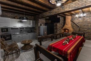 a kitchen with a table and a kitchen with a stove at Никонел in Oborishte