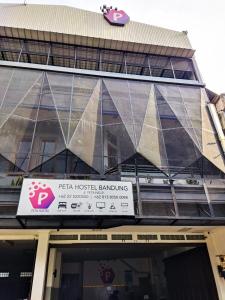 a building with a sign on the front of it at PETA HOSTEL Bandung in Bandung