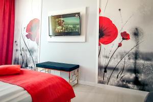 1 dormitorio con 1 cama y TV en la pared en Continental Forum Arad, en Arad