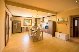 a kitchen and dining room with a table and chairs at Villa Es Figueral in Campos