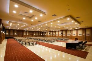 a large room with rows of tables and chairs at Admiral Hotel - Ultra All Inclusive & Private Beach in Golden Sands +96 photos