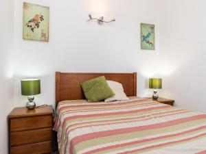 a bedroom with a bed and two lamps on night stands at Akisol Rocha Mar in Portimão
