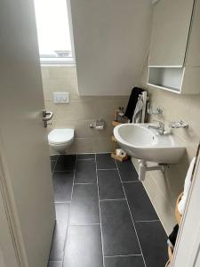 a bathroom with a sink and a toilet at Gemütliche & zentrale Wohnung in der Stadt Zürich in Zürich