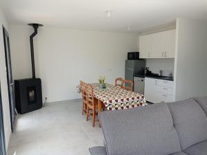 a living room with a table and a kitchen at Maison neuve - Mesquer - Plage, Rando, Vélo in Mesquer
