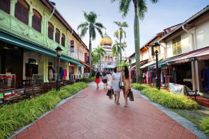 a group of people walking down a street at Pan Pacific Serviced Suites Beach Road, Singapore in Singapore