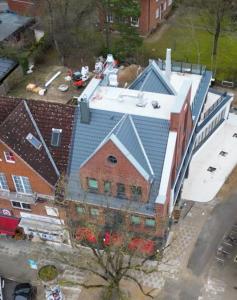 an overhead view of a building with a blue roof at Clounys Hotel in Hamburg