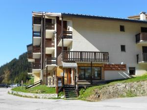 a building with a staircase in front of it at Appartement 2 pièces cabine, 100m pistes, parking gratuit - FR-1-297-127 in Auris +9 photos