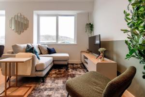 a living room with a couch and a tv at Stirling Redhill by Pay As U Stay in Redhill