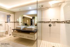 a large bathroom with two sinks and a shower at The Jewel B&B in Cape Town