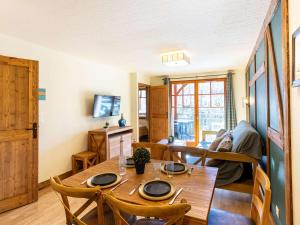 ein Esszimmer mit einem Holztisch und Stühlen in der Unterkunft Appartement central à Saint-Lary avec piscine, sauna et parking sécurisé - FR-1-296-398 in Saint-Lary-Soulan