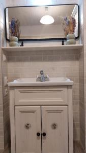 a bathroom with a sink and a mirror at Apartament Mar&Mel in Głuchołazy