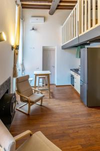 a kitchen with a table and a chair and a refrigerator at Solmi Home in Modena