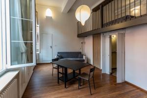 a living room with a table and a couch at Solmi Home in Modena