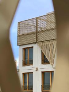 a view of a building through a window at Ecla Paris Villejuif in Villejuif